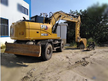 Riteņu ekskavators CATERPILLAR M315