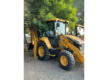 Ekskavators-iekrāvējs CATERPILLAR