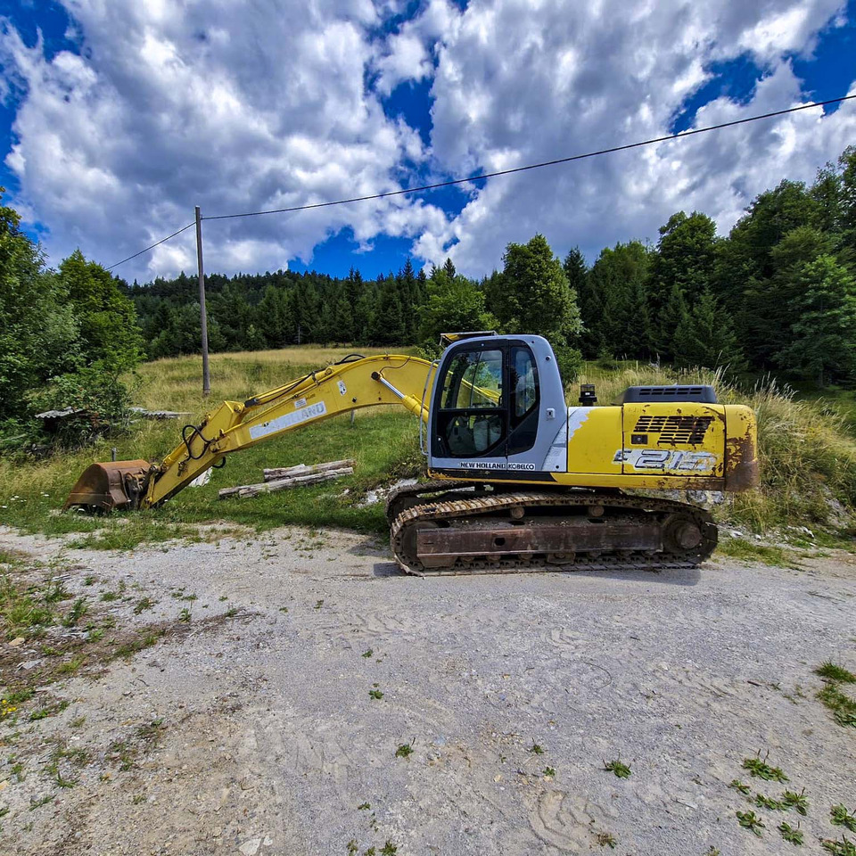 New Holland Kobelco E215 - Kāpurķēžu ekskavators: foto 1 New Holland Kobelco E215 - Kāpurķēžu ekskavators: foto 1