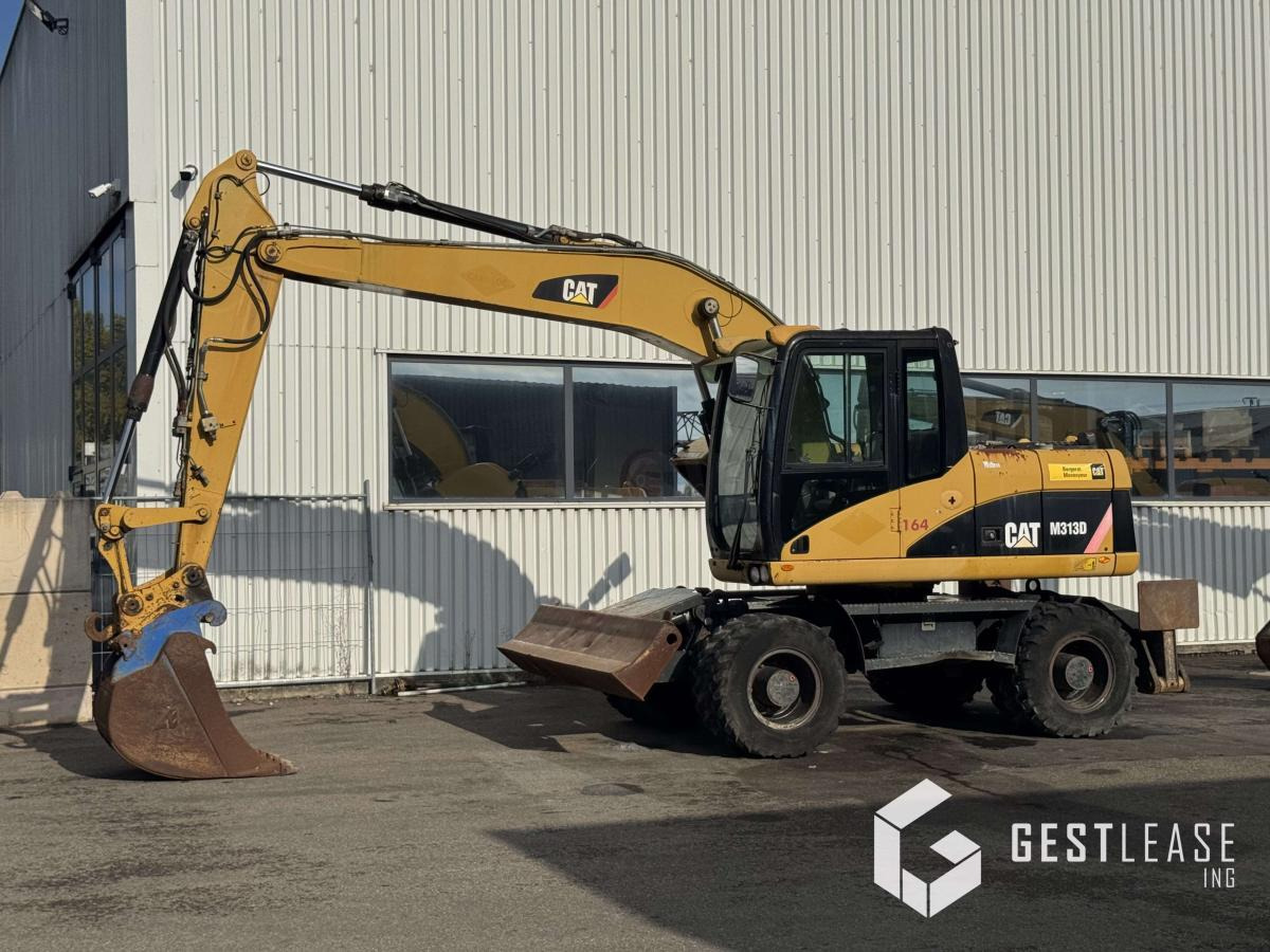 Caterpillar M313D - Riteņu ekskavators: foto 1 Caterpillar M313D - Riteņu ekskavators: foto 1