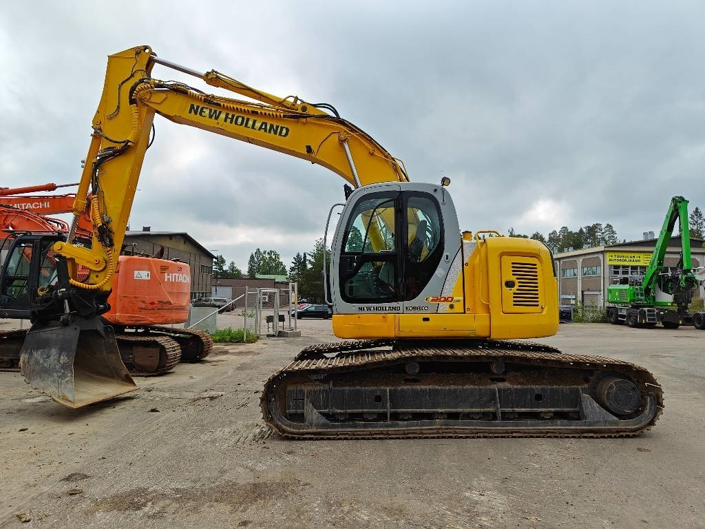 New Holland E200SRLC KALLISTUVA KAUHA - Kāpurķēžu ekskavators: foto 1 New Holland E200SRLC KALLISTUVA KAUHA - Kāpurķēžu ekskavators: foto 1