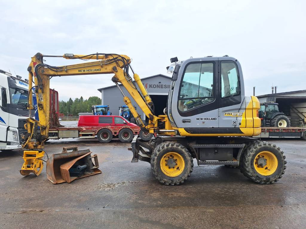 Riteņu ekskavators New Holland MH2.6 PYÖRITTÄJÄLLÄ: foto 1