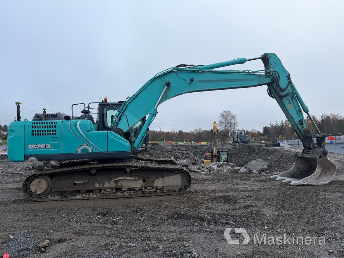 Grävmaskin Kobelco SK260LC-10 - Kāpurķēžu ekskavators: foto 4 Grävmaskin Kobelco SK260LC-10 - Kāpurķēžu ekskavators: foto 4
