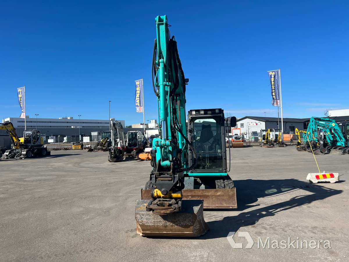 Grävmaskin Kobelco SK75SR-3E - Kāpurķēžu ekskavators: foto 2 Grävmaskin Kobelco SK75SR-3E - Kāpurķēžu ekskavators: foto 2