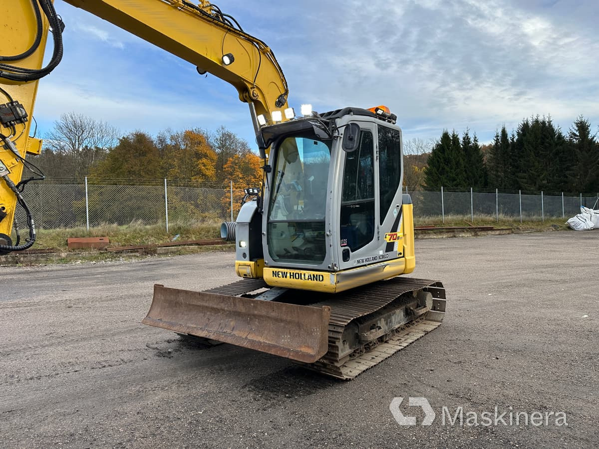 Grävmaskin New Holland Kobelco E70BSR-2 - Kāpurķēžu ekskavators: foto 4 Grävmaskin New Holland Kobelco E70BSR-2 - Kāpurķēžu ekskavators: foto 4