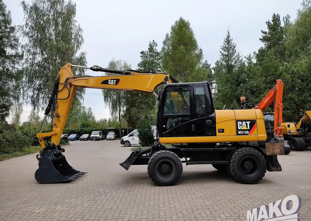 Caterpillar M313D - Riteņu ekskavators: foto 1 Caterpillar M313D - Riteņu ekskavators: foto 1