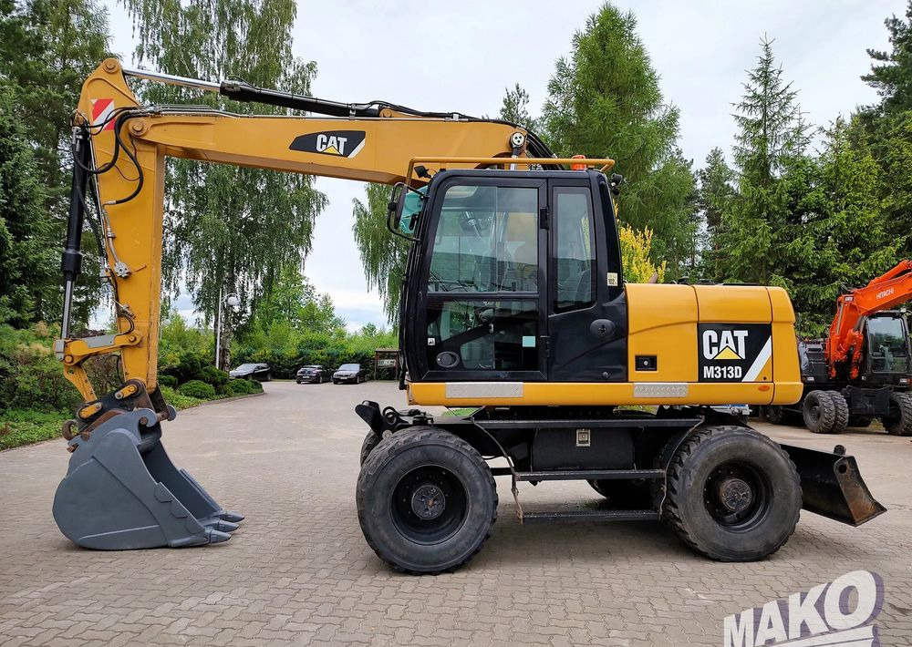 Caterpillar M313D - Riteņu ekskavators: foto 1 Caterpillar M313D - Riteņu ekskavators: foto 1