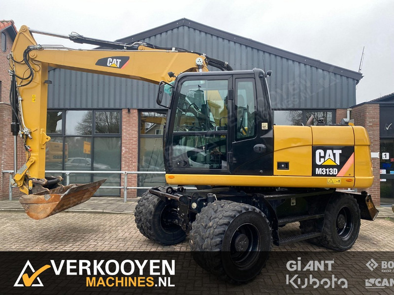 Caterpillar M313D - Riteņu ekskavators: foto 1 Caterpillar M313D - Riteņu ekskavators: foto 1