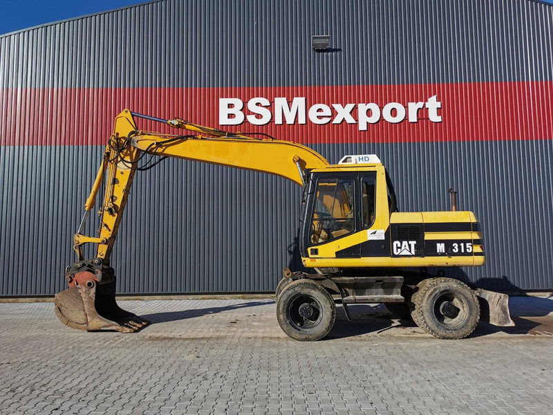 Caterpillar M315 wheel excavator - Riteņu ekskavators: foto 1 Caterpillar M315 wheel excavator - Riteņu ekskavators: foto 1