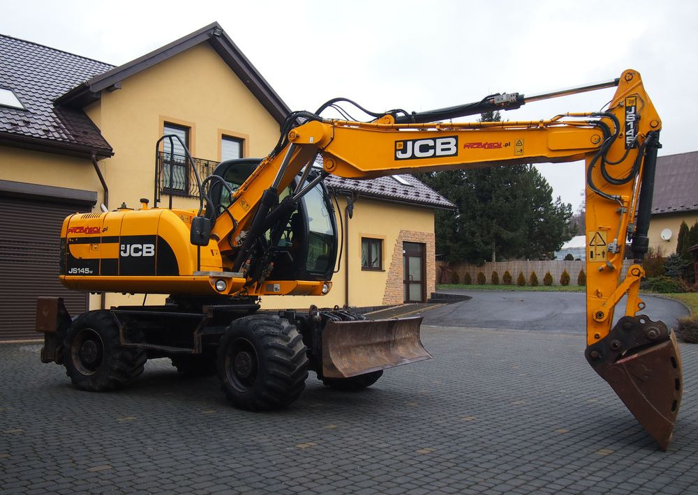 Koparka kołowa JCB JS145W 2011 Koparka JCB - Riteņu ekskavators: foto 1 Koparka kołowa JCB JS145W 2011 Koparka JCB - Riteņu ekskavators: foto 1