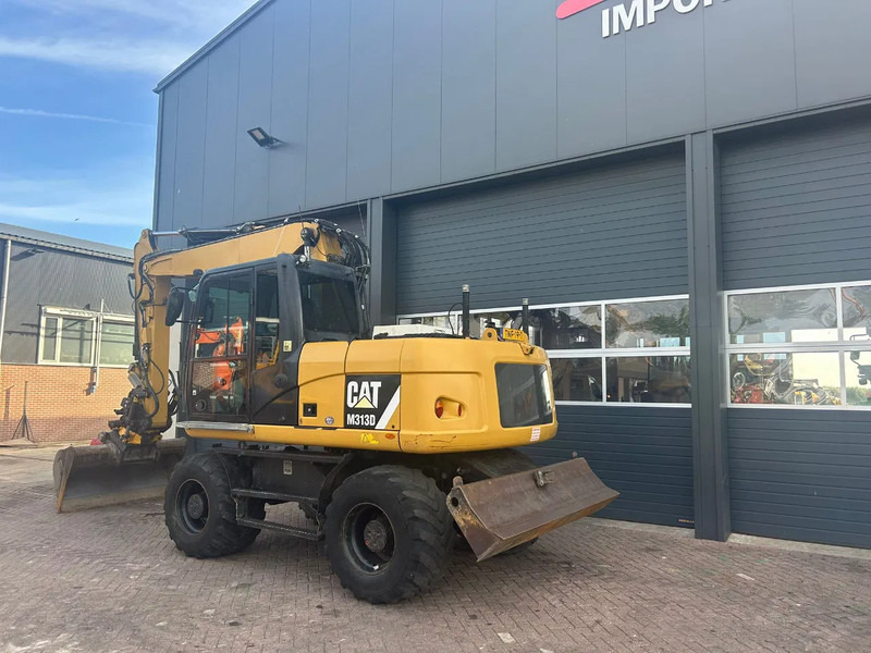 Caterpillar M313D - Riteņu ekskavators: foto 2 Caterpillar M313D - Riteņu ekskavators: foto 2