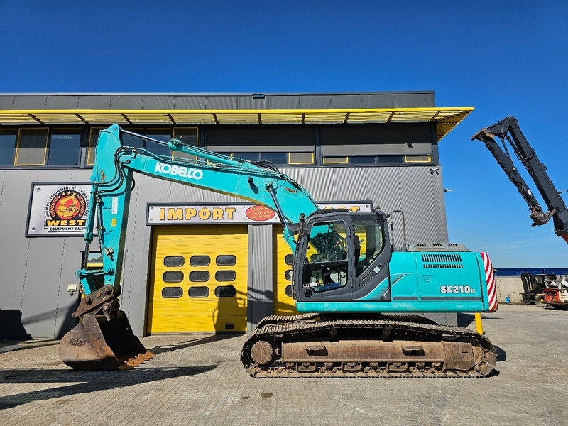 Kobelco SK210LC-9 - Kāpurķēžu ekskavators: foto 1 Kobelco SK210LC-9 - Kāpurķēžu ekskavators: foto 1