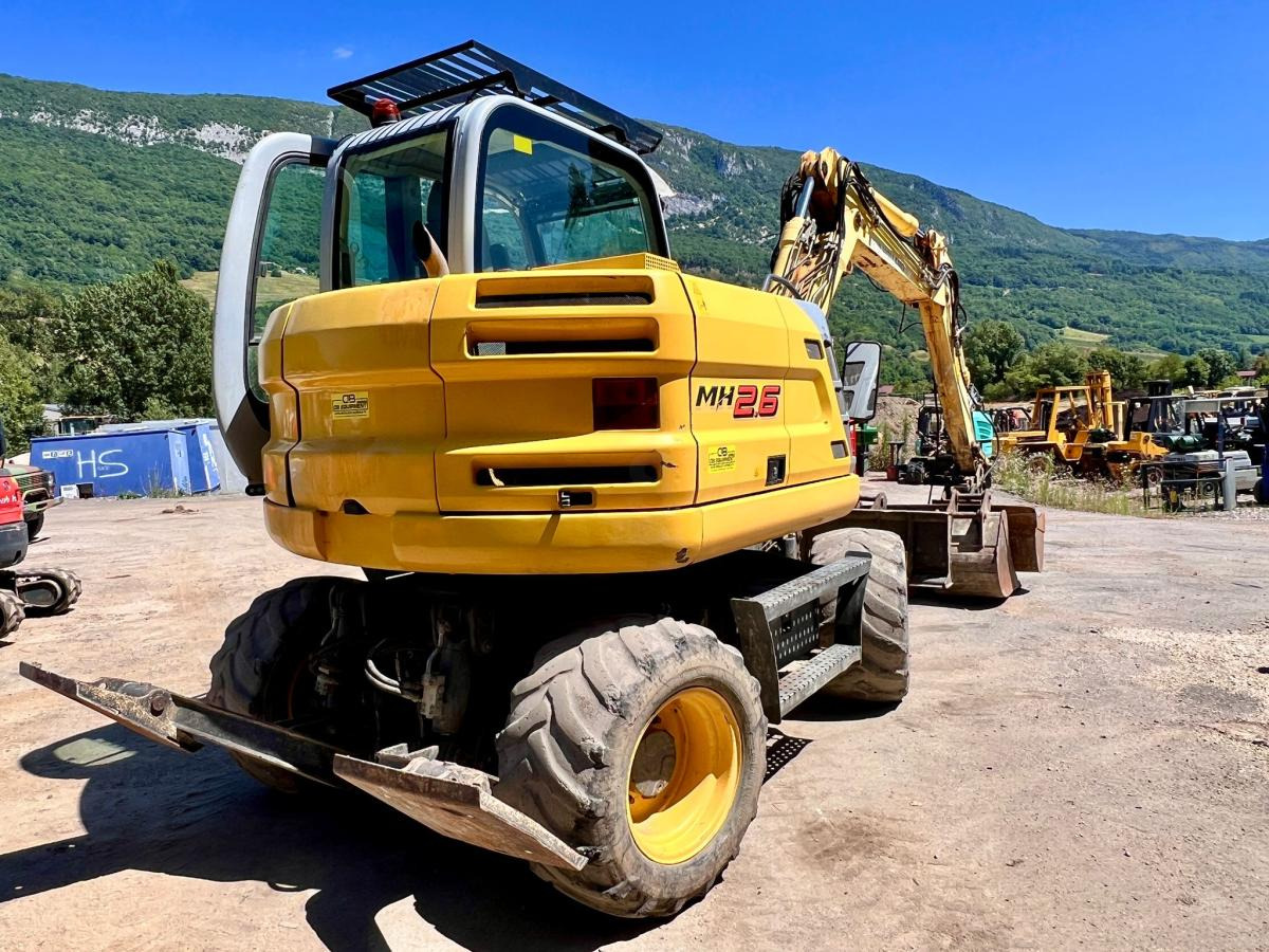 New Holland MH 2.6 PELLE A PNEUS 10T - Riteņu ekskavators: foto 4 New Holland MH 2.6 PELLE A PNEUS 10T - Riteņu ekskavators: foto 4