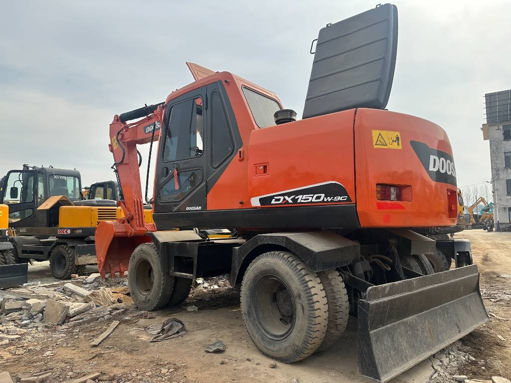 Doosan DX 150W -9 - Riteņu ekskavators: foto 1 Doosan DX 150W -9 - Riteņu ekskavators: foto 1