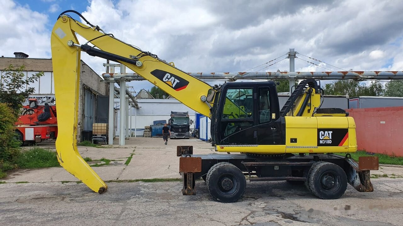 Caterpillar M 318 D MH - Atkritumu iekrāvējs: foto 1 Caterpillar M 318 D MH - Atkritumu iekrāvējs: foto 1