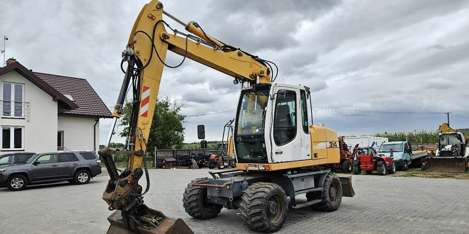 Koparka kołowa Liebherr A314 Litronic 9350 h 4 łyżki kołówka - Riteņu ekskavators: foto 2 Koparka kołowa Liebherr A314 Litronic 9350 h 4 łyżki kołówka - Riteņu ekskavators: foto 2