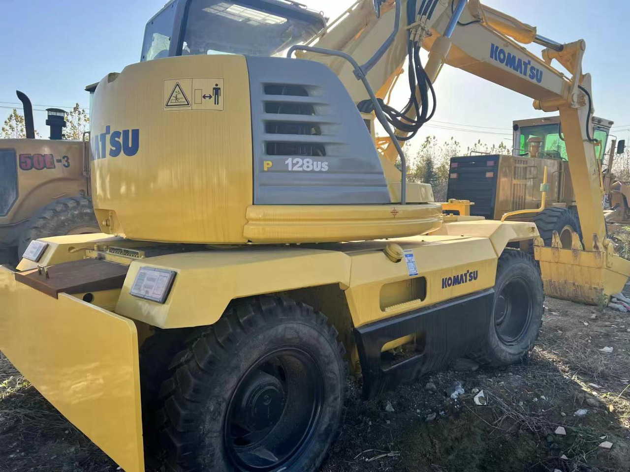 KOMATSU PC128US - Riteņu ekskavators: foto 2 KOMATSU PC128US - Riteņu ekskavators: foto 2