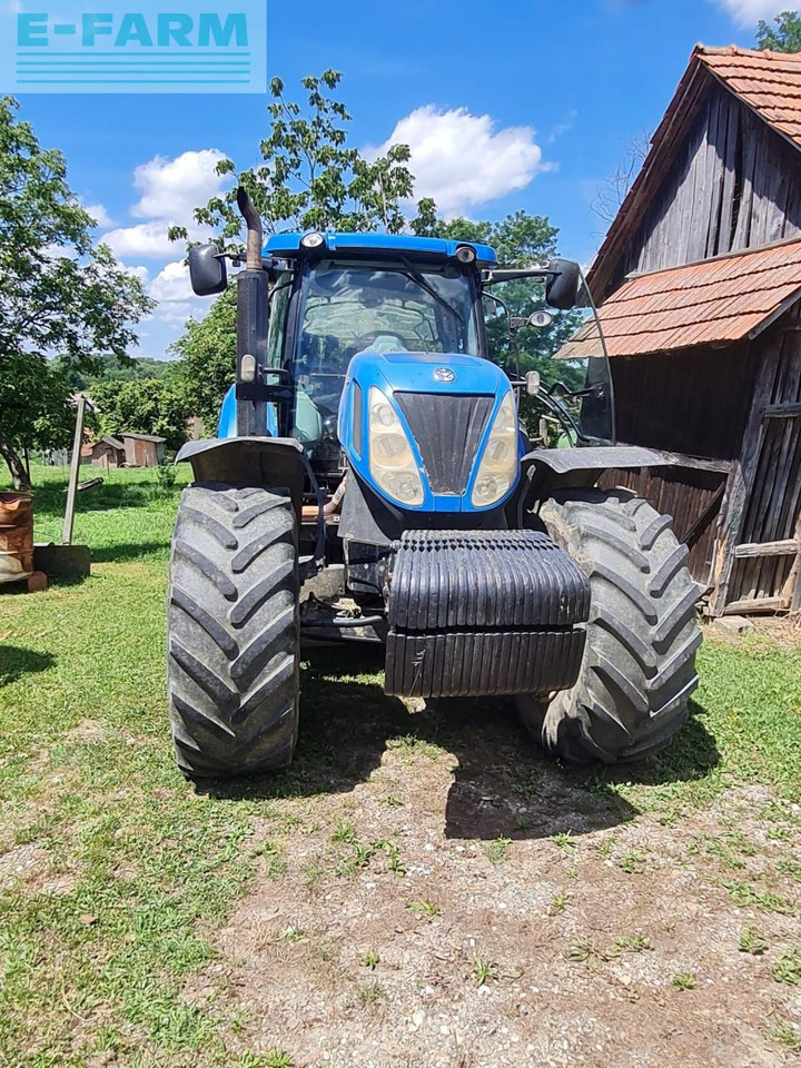 New Holland T7050 - Traktors: foto 1 New Holland T7050 - Traktors: foto 1