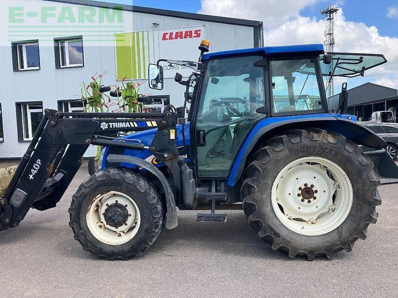 New Holland tl 100 a A - Traktors: foto 1 New Holland tl 100 a A - Traktors: foto 1