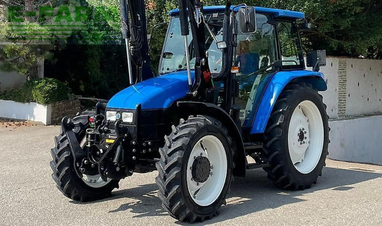 New Holland tl100 (4wd) - Traktors: foto 1 New Holland tl100 (4wd) - Traktors: foto 1