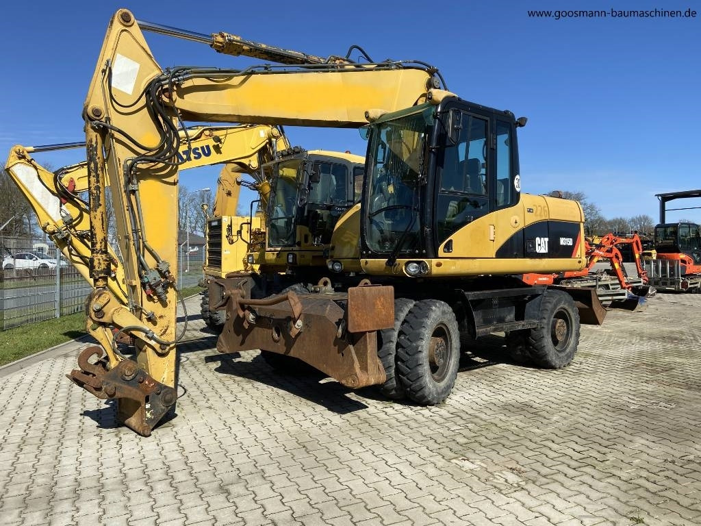 CAT M 315 D - Riteņu ekskavators: foto 1 CAT M 315 D - Riteņu ekskavators: foto 1